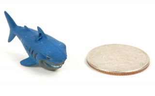 This set of 10 mini plastic shark charms are great as party favors